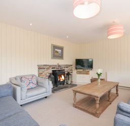 A living room with a coffee table and fireplace at Porthilly Brook in Rock
