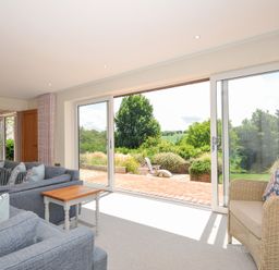 A living room with a sofa and armchair at Porthilly Brook in Rock
