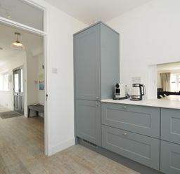 A kitchen with cupboards and appliances at Corriana in Rock