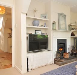 A living room with a TV and fireplace at Sandy Lodge Rock