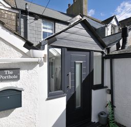 An entrance with a door and mailbox at The Porthole in Port Isaac