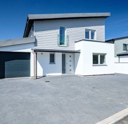A modern two-story house with a garage and paved driveway at Artemis in Rock