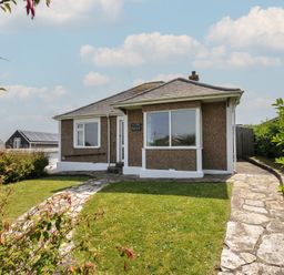 A house with a garden and pathway at Hillcroft Bungalow Daymer Bay