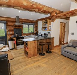 A kitchen with a countertop and dining area at Douglas Cabin at Salford Court Farm Fishing Cabins Near Clifton Upon Teme