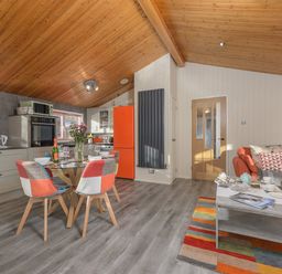 A kitchen and dining area with a wooden ceiling and orange accents at Oaks One Swarland near Felton