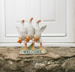 A welcome decoration with three white ducks in front of a white door at Orchard House Cottage in Malmesbury