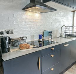 A kitchen with a countertop, stove, and sink at 7 Bro Branwen near Rhosneigr