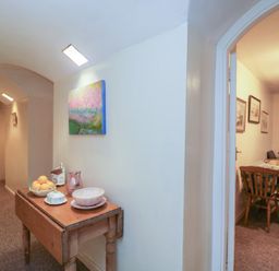 A hallway with a table and chair at Dollar Ward House Basement Cirencester