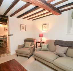 A living room with a sofa and armchair at Butlers Cottage in Burford
