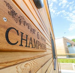 A wooden nameplate with the number 6 and the word Champagne on the exterior wall of a wooden building at Champagne in Seaview