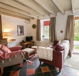 A living room with a sofa and television at Sycamore Vestry in Pontfaen near Fishguard