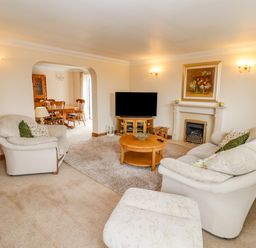 A living room with sofas a coffee table a television and a fireplace at Corner House in Cinderford