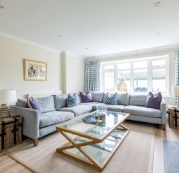 A living room with a gray sectional sofa and a glass coffee table at Silverdale in Rock