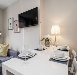 A living room with a dining table and sofa at 24 Baxtergate in Whitby