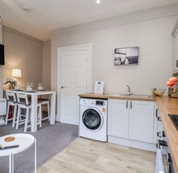 A kitchen area with a table and chairs at 24 Baxtergate in Whitby