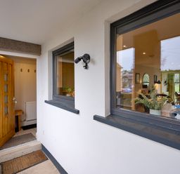 An entrance with a wooden door and a bench at Riverside Park 3 in Keswick