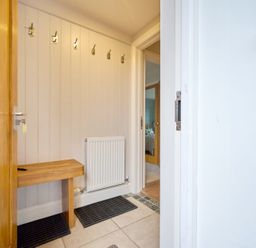 A hallway with hooks and a bench at Riverside Park 3 in Keswick