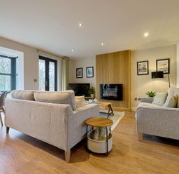 A living room with a sofa and table at Riverside Park 3 in Keswick