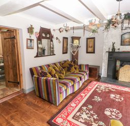 A living room with a sofa and fireplace at The Woodlands Lower Level Stepaside