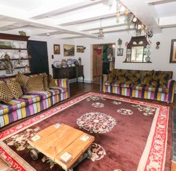 A living room with sofas and a table at The Woodlands Lower Level in Stepaside