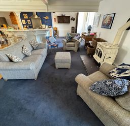 A living room with sofas and a fireplace at Bethel Chapel in Staithes