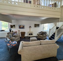 A living room with sofas and a fireplace at Bethel Chapel in Staithes