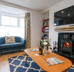 A living room with a sofa and coffee table at Bryn Awel in Mynytho near Abersoch