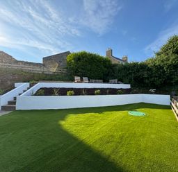 A garden with steps and plants at Cromlin Glas in Abersoch
