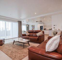 A living room with a sofa and coffee table at 13 Cliff Edge in Newquay
