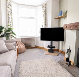A living room with a sofa plant tv bean bag and fireplace at Dovestones in Keswick