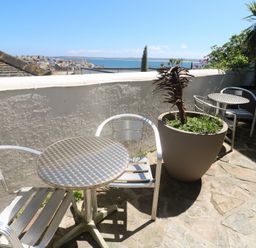 A terrace with chairs and a table at Heron in St Ives