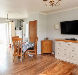 A dining room with a table and chairs at Bro Mebyd in Criccieth