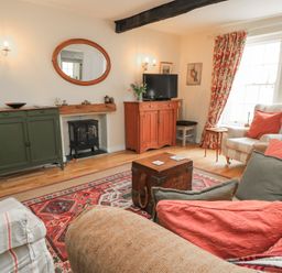 A living room with a sofa and coffee table at 4 Duck Street in Dorchester
