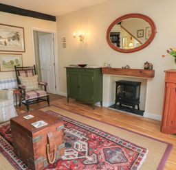 A living room with a table, cabinets, and artworks at 4 Duck Street in Dorchester