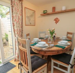A dining room with a round table and chairs at 4 Duck Street Dorchester