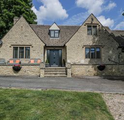 A house with stone walls and outdoor seating at Bell Garden in Stow-On-The-Wold