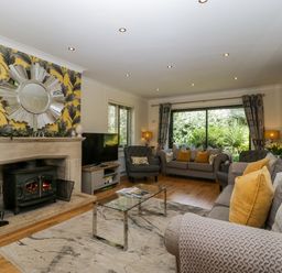 A living room with a fireplace and sofa at Bell Garden in Stow-On-The-Wold