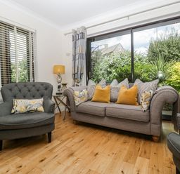 A living room with a sofa and chairs at Bell Garden in Stow-On-The-Wold