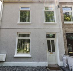 The exterior front view of a two-story house with a white door and three white-framed windows at 5 Pontardulais Road Llangennech