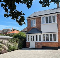 A house with a driveway and garden at The Chocolate Box in Weymouth