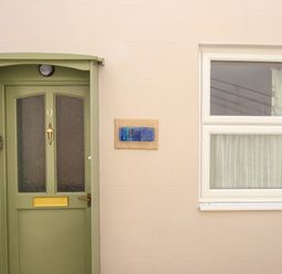 A green door with the number nine and a window with curtains at Blanche Cottage in Brewers Quay Harbour