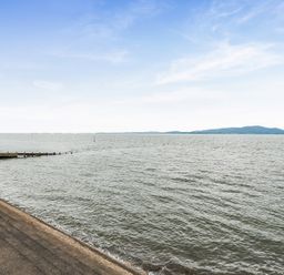 A view of water with a pier in the foreground at Solway View, Skinburness near Silloth