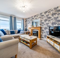 A living room with a sofa and television at Solway View in Skinburness near Silloth