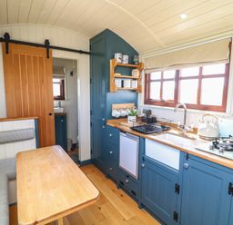 A kitchen with a sink and stove at Sweet Caroline Shepherd’s Hut Low Marnham near Sutton-On-Trent