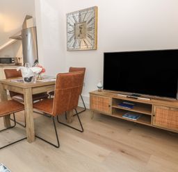 A dining room with a table and chairs at Upper Deck in Truro