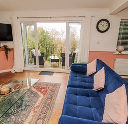 A living room with a sofa and television at Lake View in Bowness-On-Windermere