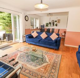 A living room with a coffee table and foosball table at Lake View in Bowness-On-Windermere
