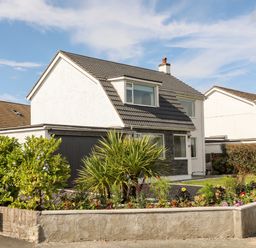 A two-story house with a tiled roof and garden at Dolwyn in Llandegfan