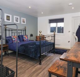 A bedroom with a bed and a desk at Chalet 5 in Sherburn
