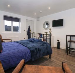 A bedroom with a bed and TV at Chalet 5 in Sherburn